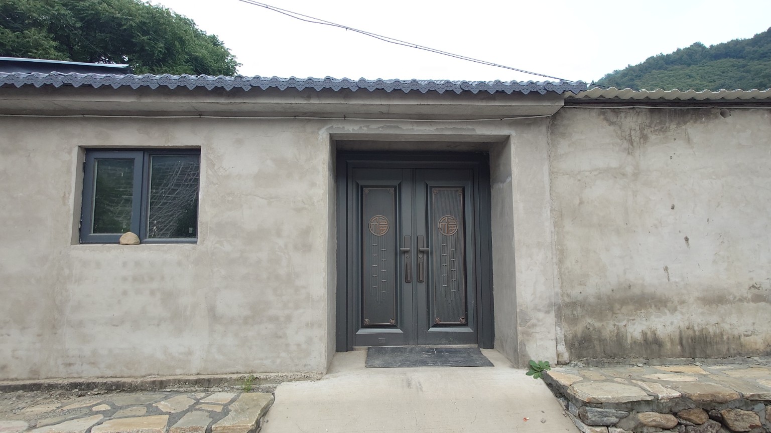 A newly renovated country courtyard with modern doors and windows