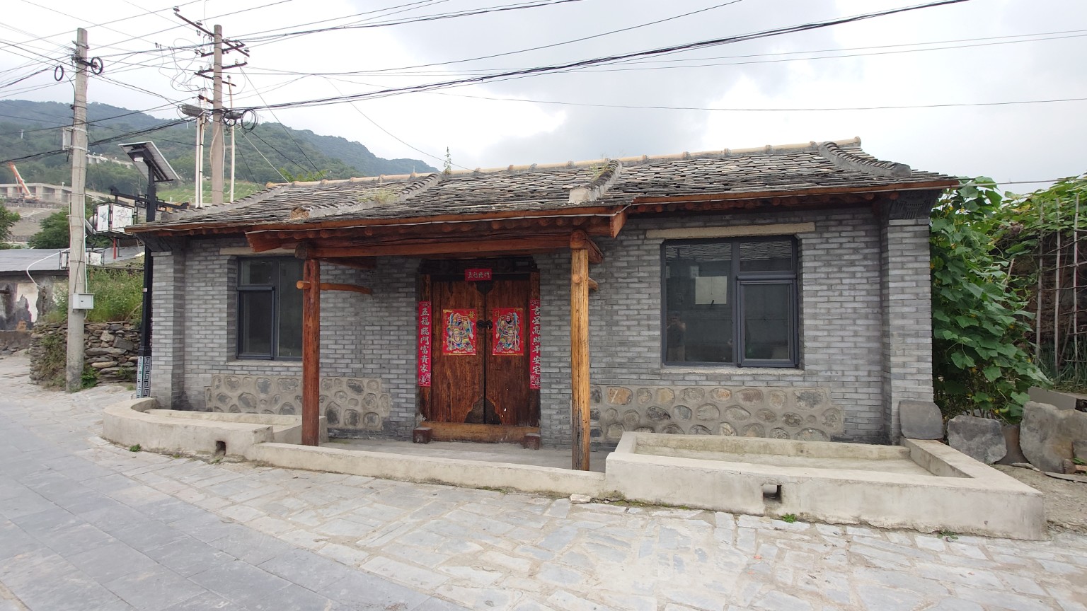 A reinforced grey-brick and stone courtyard house beside Nanjiao’s old lane