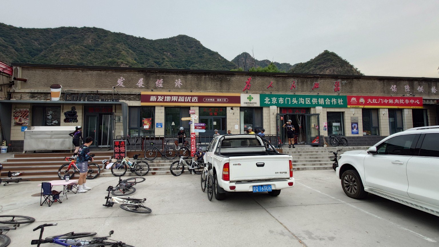 Cyclists gather outside Yanchi’s supply and marketing cooperative, fruit shop and coffee stop