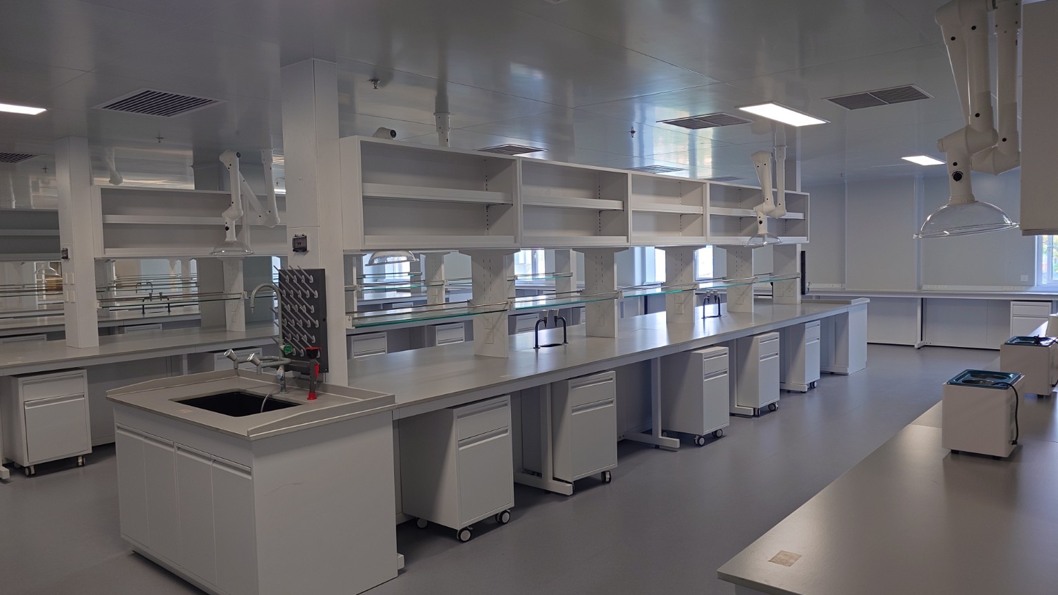 Shared laboratory in the Shunyi dental-device base, with benches, sinks and overhead extraction arms